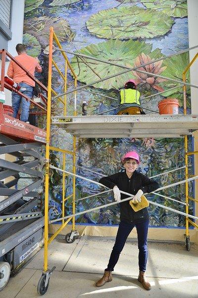 Dixie Friend Gay in front of the nearly completed mural  Photo by John Fulbright